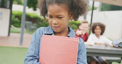 Video of sad biracial schoolgirl being taunted by two boys in schoolyard