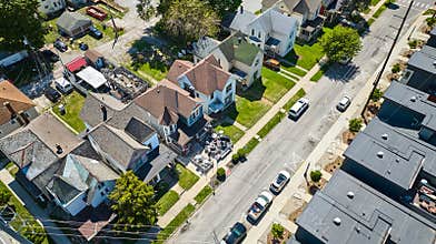 Neighborhood landscape aerial summer cookout firepit patio space downtown green lawns houses