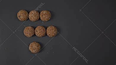 Cookies arranged in a row, black background, the consumer chooses two