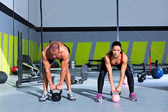 Kettlebells swing crossfit exercise man and woman