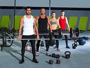 Gym group with weight lifting bar crossfit workout