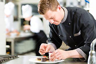 Chef as Patissier cooking in Restaurant dessert