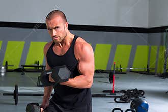 Gym man with dumbbells exercise crossfit