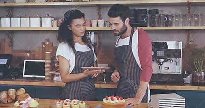 Animation of graphs moving over multiracial coworkers discussing over digital tablet in cafe