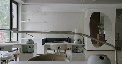 Modern interior in nail salon, chairs and table with lamp