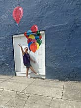 senior adult woman holding balloons