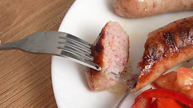 Close-up of Eating deliciously grilled Sausage
