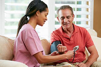 Nurse Visiting Senior Male Patient At Home