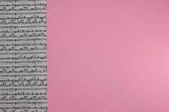 musical notes on the left side of the background next to pink copy space, creative music background, art design