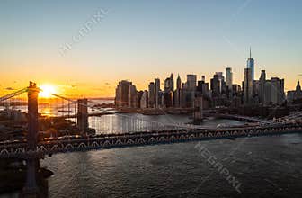 Aerial panoramic view of modern office towers on Lower Manhattan at sunset. Romantic evening shot of bridges over East