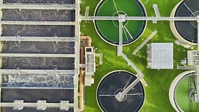 Aerial view of modern water cleaning facility at urban wastewater treatment plant. Purification process of removing
