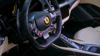 Moscow, Russia - CIRCA 2022: Close up view of interior of convertible coupe car with open red roof of sports ferrari