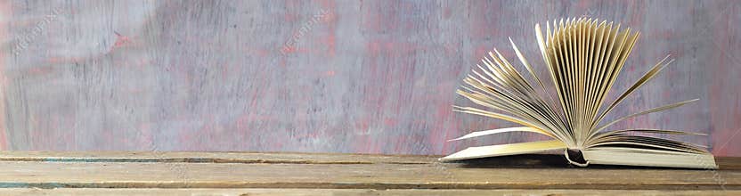 Open book, vintage hardback book  on grungy  background. Education, reading, learning  concept