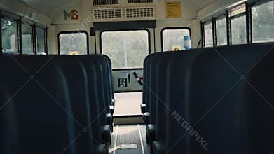 Interior school bus staying empty on parking close up. Vehicle comfortable seats