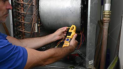 HVAC Technician Checking Current on Motor Wire
