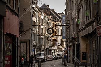 Rue du pont, a decaying street of the city center of Liege, with facade of old buildings