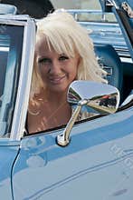 Blond smiling woman in a car