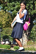 Female Student Wearing School Uniform Holding Books