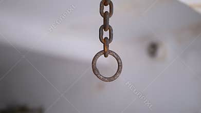 Motion of Rusty Iron Chain Suspended from the Ceiling in Torture Room. Close up