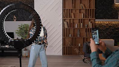 A brunette teen dancing hip hop at home