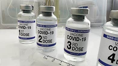 COVID-19 Vaccine Vials for vaccination tagged with 1st, 2nd, 3rd, and 4th dose