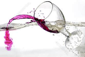 Falling a glass of red wine into water