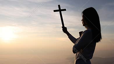 Woman praying to god with cross in the morning, woman praying to god for a better life Christian Crisis Prayer to God