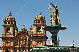 Statue of Inca Pachacutec on fountain and catholic church on Plaza de Armas,