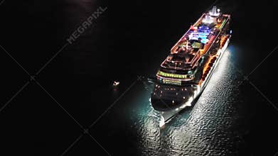 illuminated cruise ship in sea at night