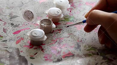 Aspiring artist amateur diligently and paints neatly with a brush