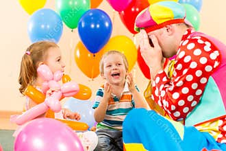 Happy children and clown on birthday party