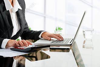 Female office worker doing accounting.