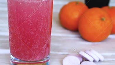 Close-up Vitamin pop with water. The concept of drinking vitamin c in tablets. Fruit juice or freshly squeezed. Medicinal