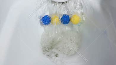 Top view flush toilet bowl with water. Scented balls for the toilet.