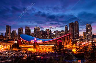 Sunset blue hour over Calgary city downtown skyline with the city's iconic Saddledome arena in the foreground