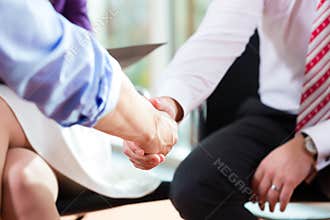 Man shaking hands with manager at job interview