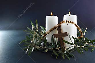 Easter religious background with candles cross and olive branches