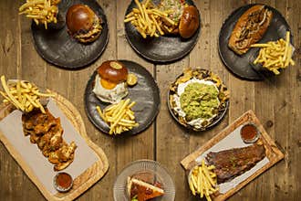 Set of fast food dishes with many burgers, bbq ribs, buffalo wings,
