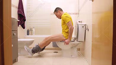 Man struggles with painful diarrhea in bathroom