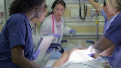Medical Team Working On Patient In Emergency Room