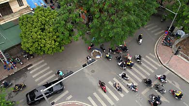 Aerial of busy Hanoi intersection with scooters and daily street life, Vietnam