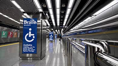 Accessible subway platform with braille signage, audio guidance, tactile paving, and guide rails supporting independent