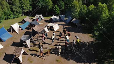 Refugees running in refugee camp in forest