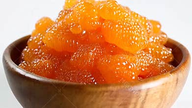 Close Up of Mandarin Orange Segments in Wooden Bowl against White Backdrop