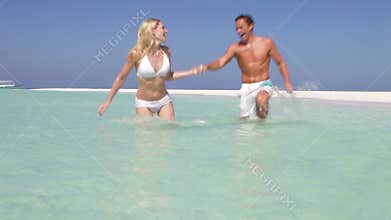 Couple Splashing In Beautiful Tropical Sea