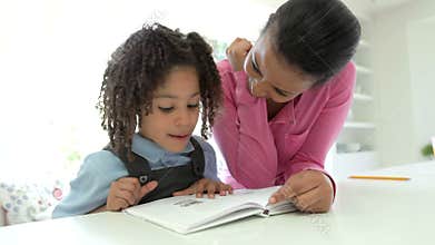 Mother Helping Daughter With Homework