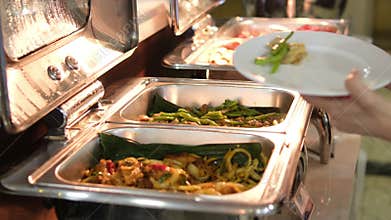 Catering banquet table with appetizers, canapés in restaurant or hotel against background of window night roads cars