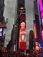 Times Square scene with digital billboards, including a \"2025 Pope Leo XIV\" display.