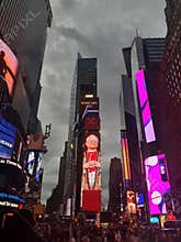 Times Square scene with digital billboards, including a \"2025 Pope Leo XIV\" display.