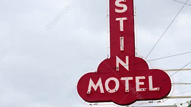 A nostalgic video of a vintage motel sign evokes longing and adventure